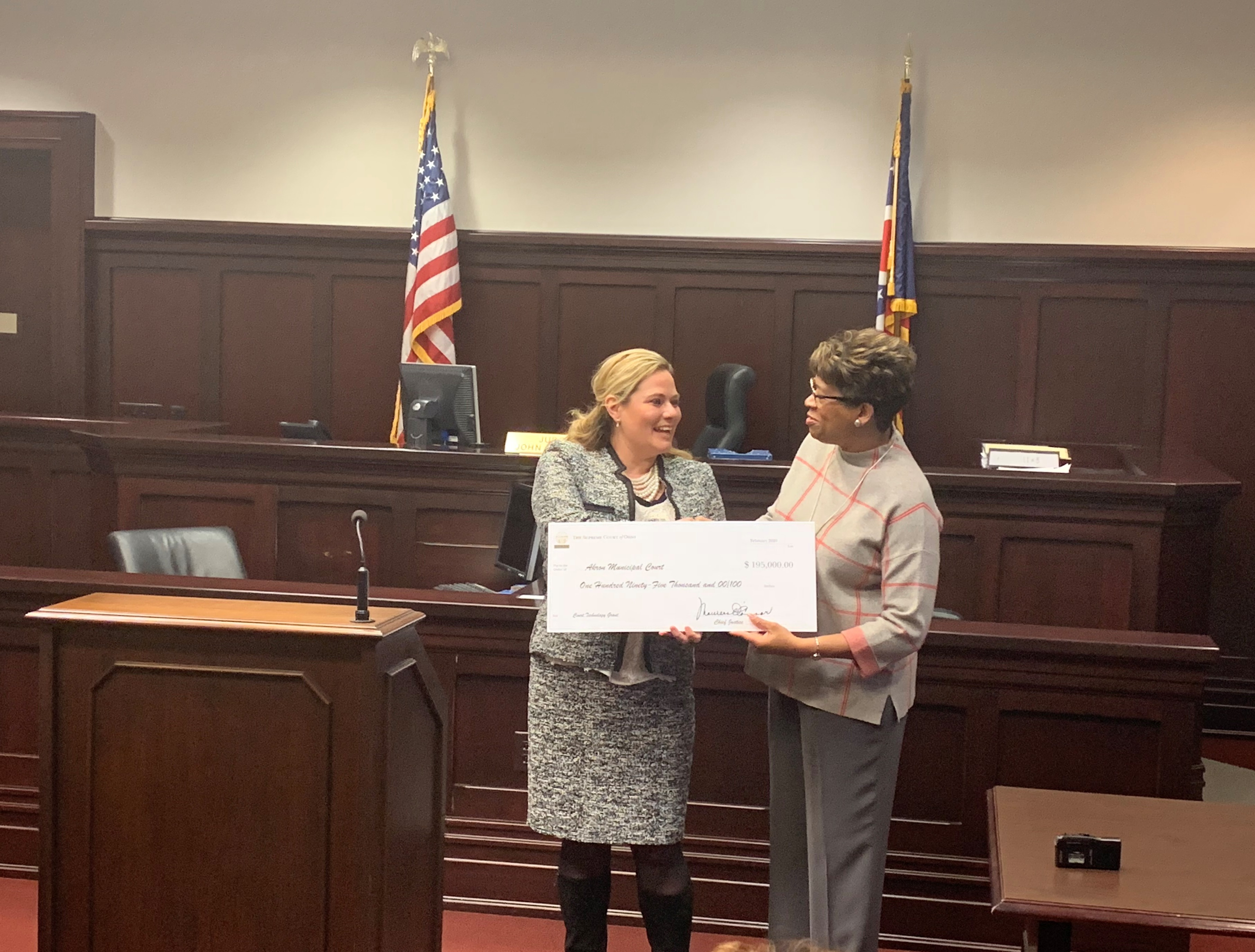 Ohio Supreme Court Justice Melody Stewart presents a Technology Grant check to Akron Municipal Court Administrative/Presiding Judge Nicole Walker