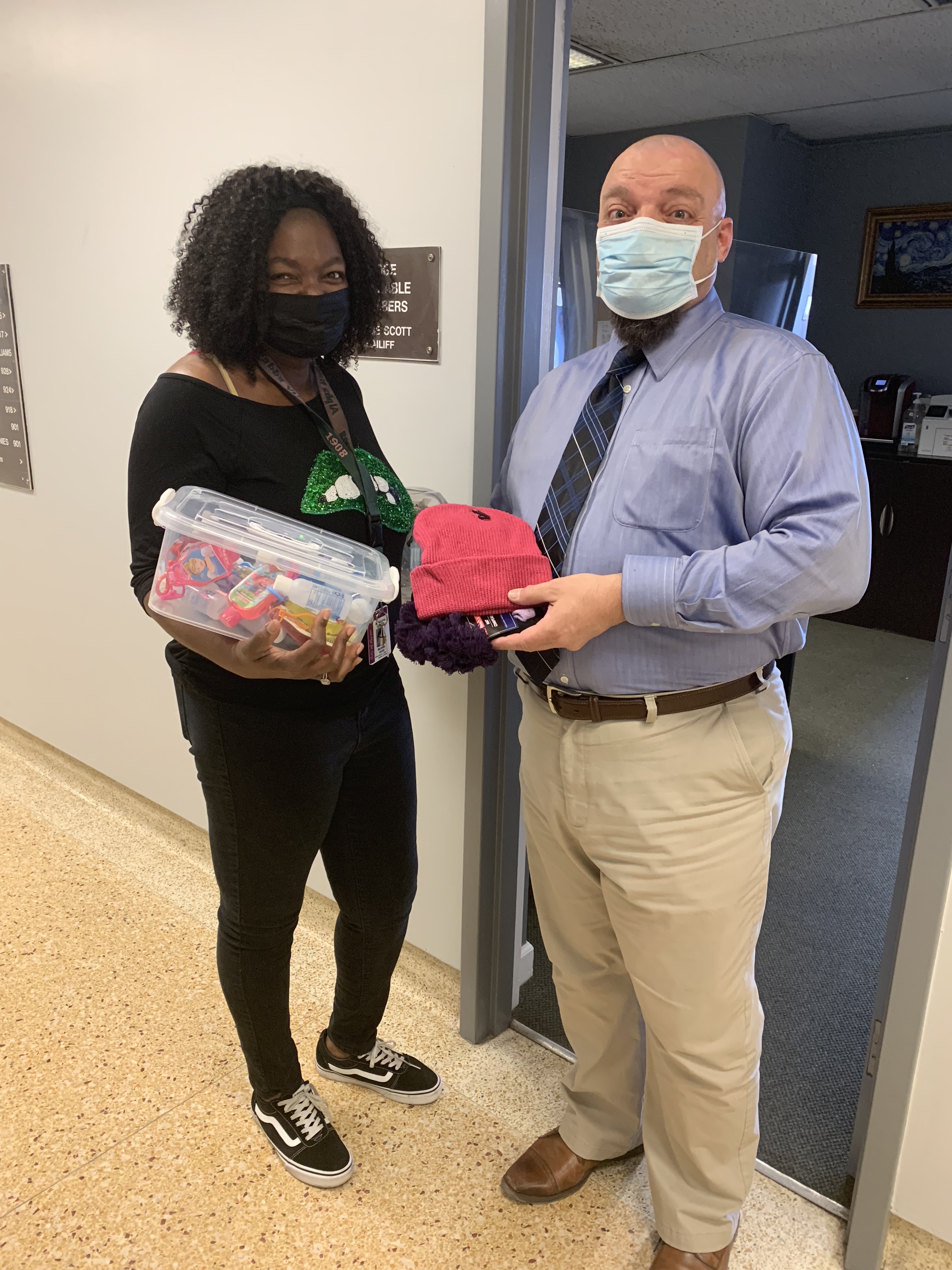 Deputy Chief Service Bailiff David Soder and Probation Officer Michelle Smith hold a portion of the donations